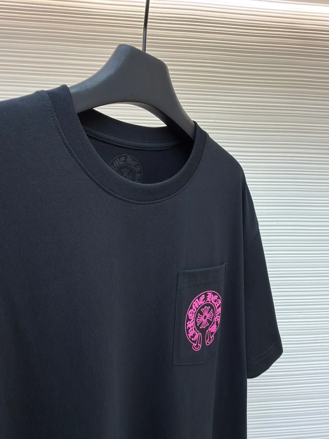 Chrome Hearts horseshoe pink T-shirt ●Item number: 1682508-X85 ●Fabric: cotton fabric ●Technology: hand-printed with ink ●Color: black ●Version: loose fit ●Weight: about 290 grams ●Size: S-M-L ●Description: This Chrome Hearts pocket printed short-sleeves are made of high-count double yarn cotton, with a weight of 320g. The fabric has been pre-washed to achieve a soft and skin-friendly touch. At the same time, it avoids shrinkage and fading problems from the root, and maintains a crisp shape after long-term wear. The body adopts seamless cylinder weaving technology, and there are no seams on the sides, so there is no sense of restraint when worn. The shoulders are classic dropped shoulders, and the loose body shape is suitable for all kinds of body shapes. The rose-red totem print on the left breast pocket is made of imported environmentally friendly slurry and produced through a high-precision screen printing process. The printing has clear layers and saturated colors, and it is not easy to crack or fall off after repeated washing. The neckline adopts a double-needle reinforced hemming design and is paired with a customized threaded collar, which is durable and not easily deformed. The overall wiring follows luxury craftsmanship standards, and the stitching is even and fine. Every detail demonstrates ingenuity. Customized hardware and accessories are complete with three logos, restoring the classic texture of the brand. The overall wiring is straight and delicate, the fabric is comfortable and soft, and the color is consistent without color difference. It can be matched with the same style to create a fashionable look and control various occasions. Customized accessories, complete with three standards, same style for men and women!